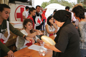 BREAKING BREAD Red Cross workers distribute food at a Gori, Georgia, refugee camp in 2008. Red Cross monitors its cold chain and must dispose of food not kept at safe temperatures. 