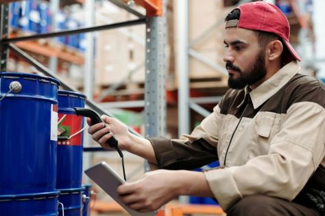 A man checking the temperature of a product in a warehouse